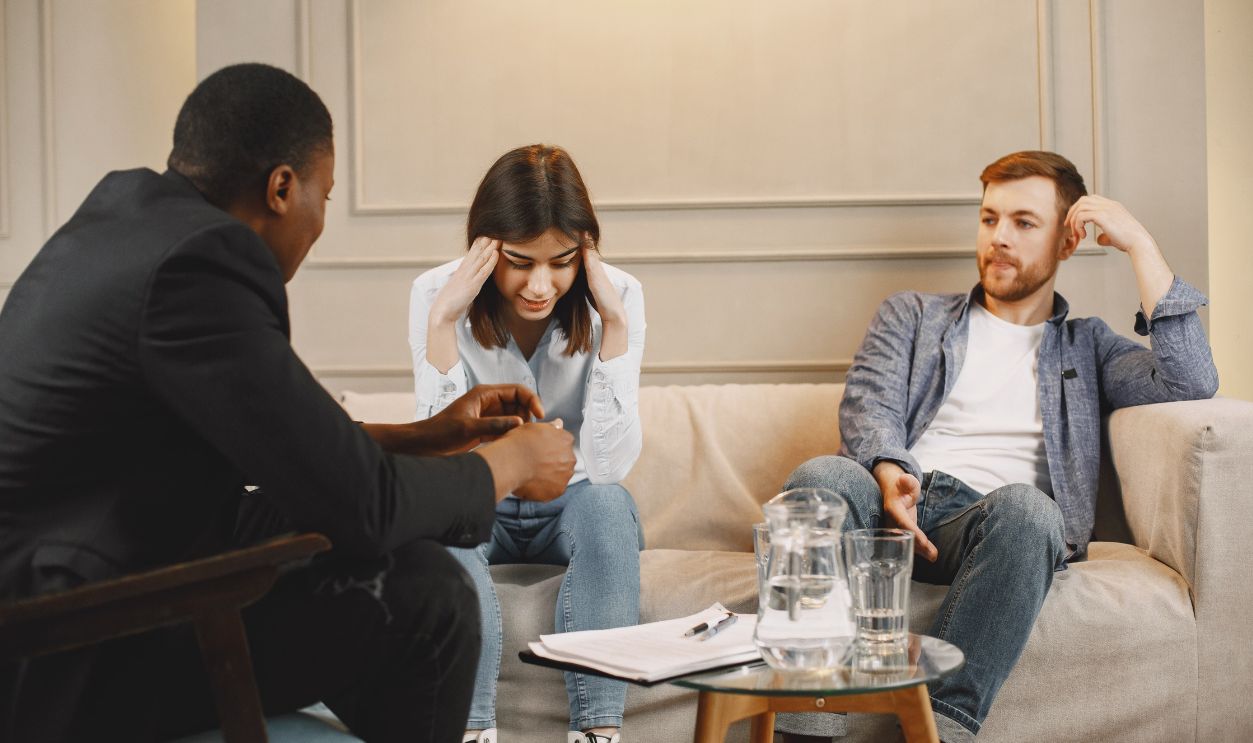 A couple attending a counseling session with a therapist, discussing their issues