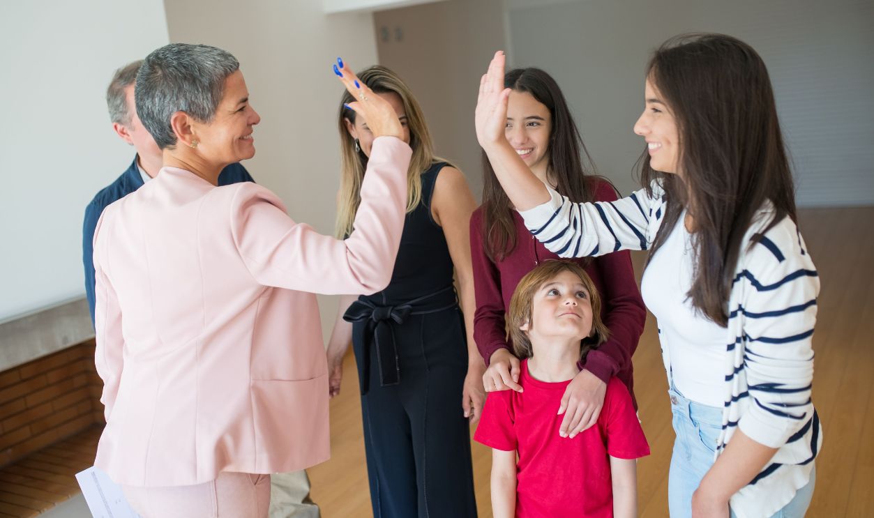 A joyful family moment with a high-five indoors, showcasing a happy family
