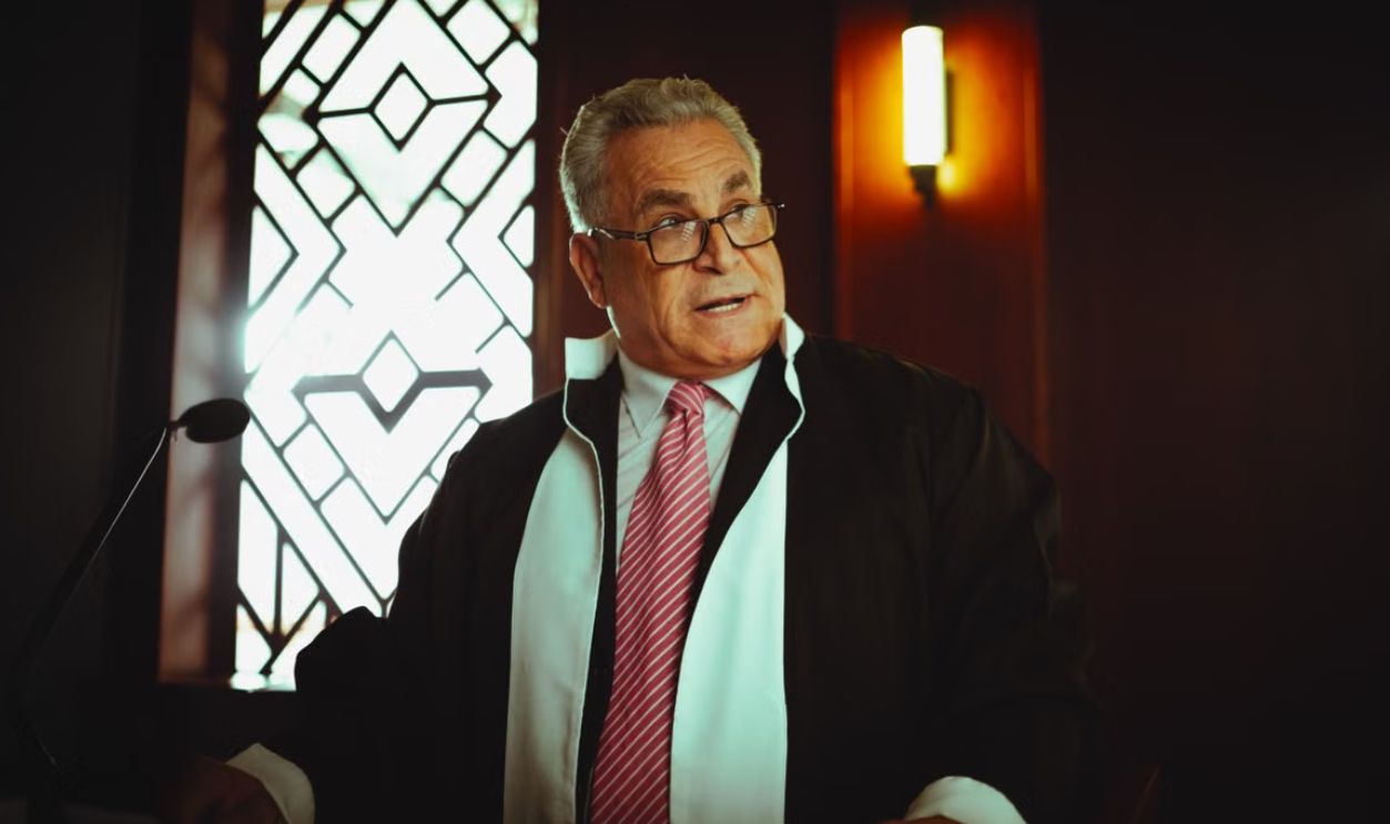 Middle-Eastern judge wearing traditional attire in a courtroom, Baghdad, Iraq.