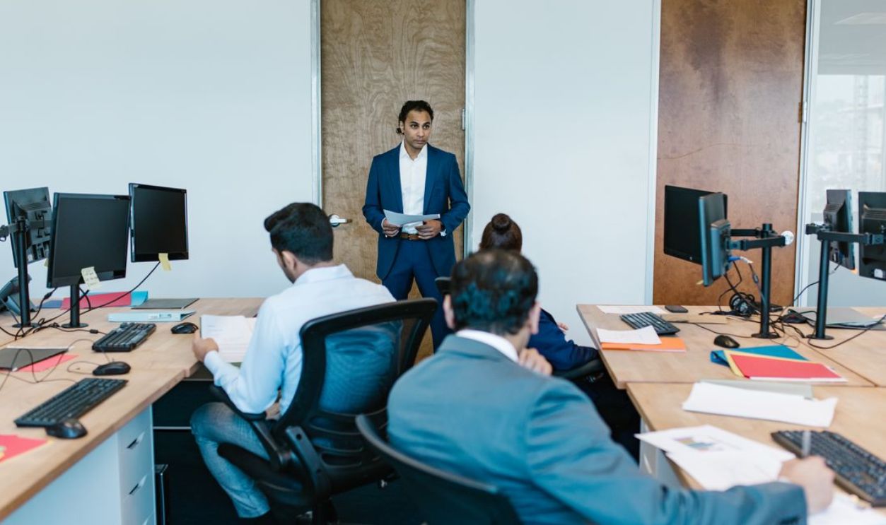 Business meeting with diverse team in modern office space, discussing projects