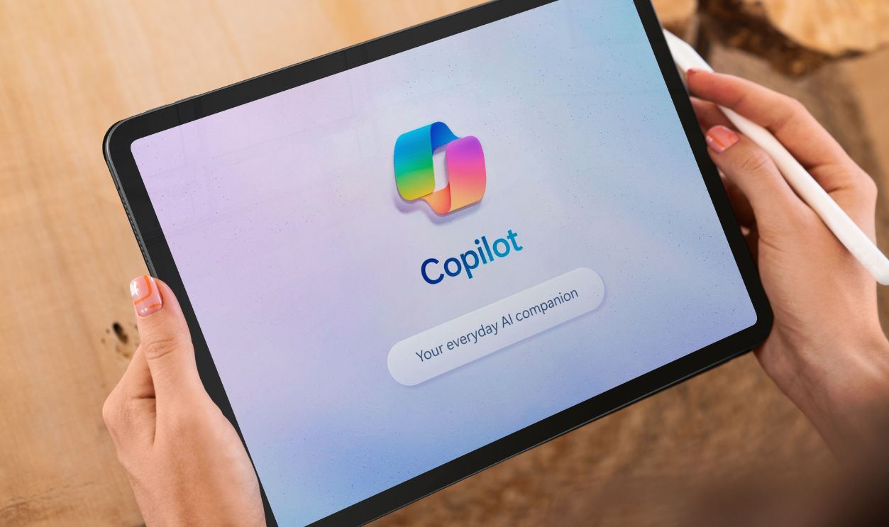 Madrid, Spain; 05 05 2025 Hands holding a tablet displaying the copilot app, an ai companion for everyday use