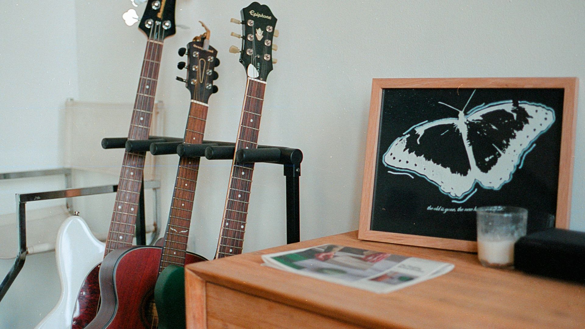 a couple of guitars sitting on top of a wooden table