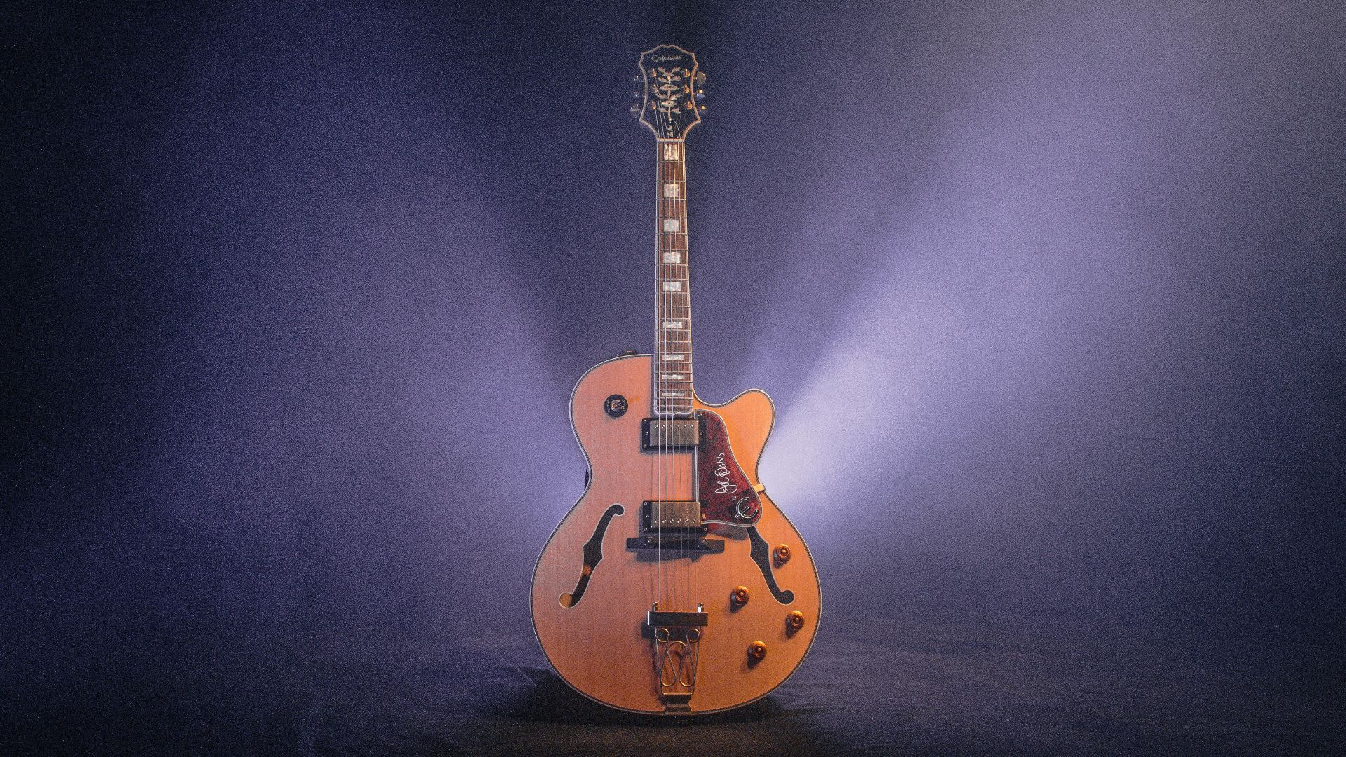 brown and black jazz guitar with dim light