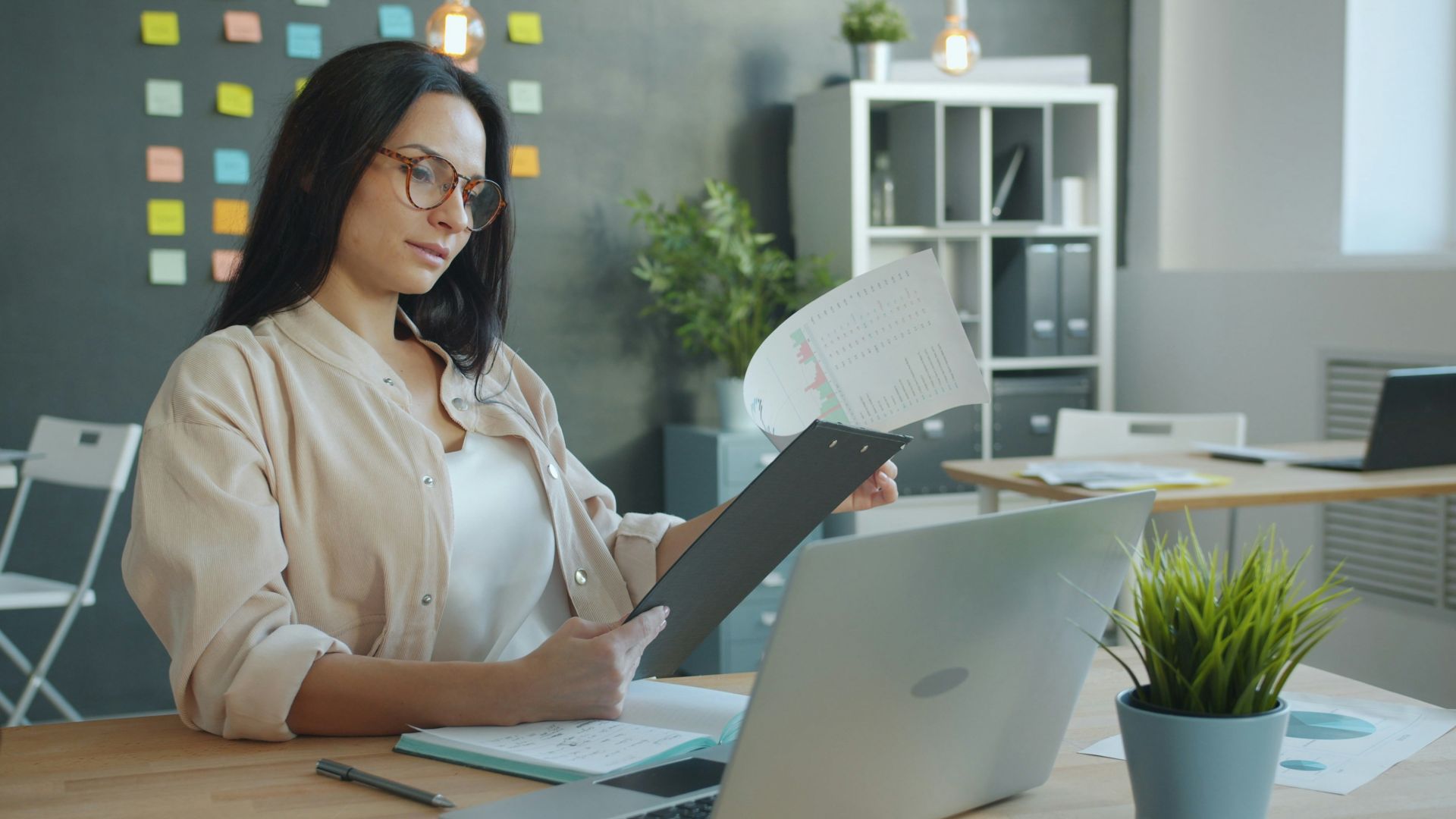 Woman working with documents at office desk