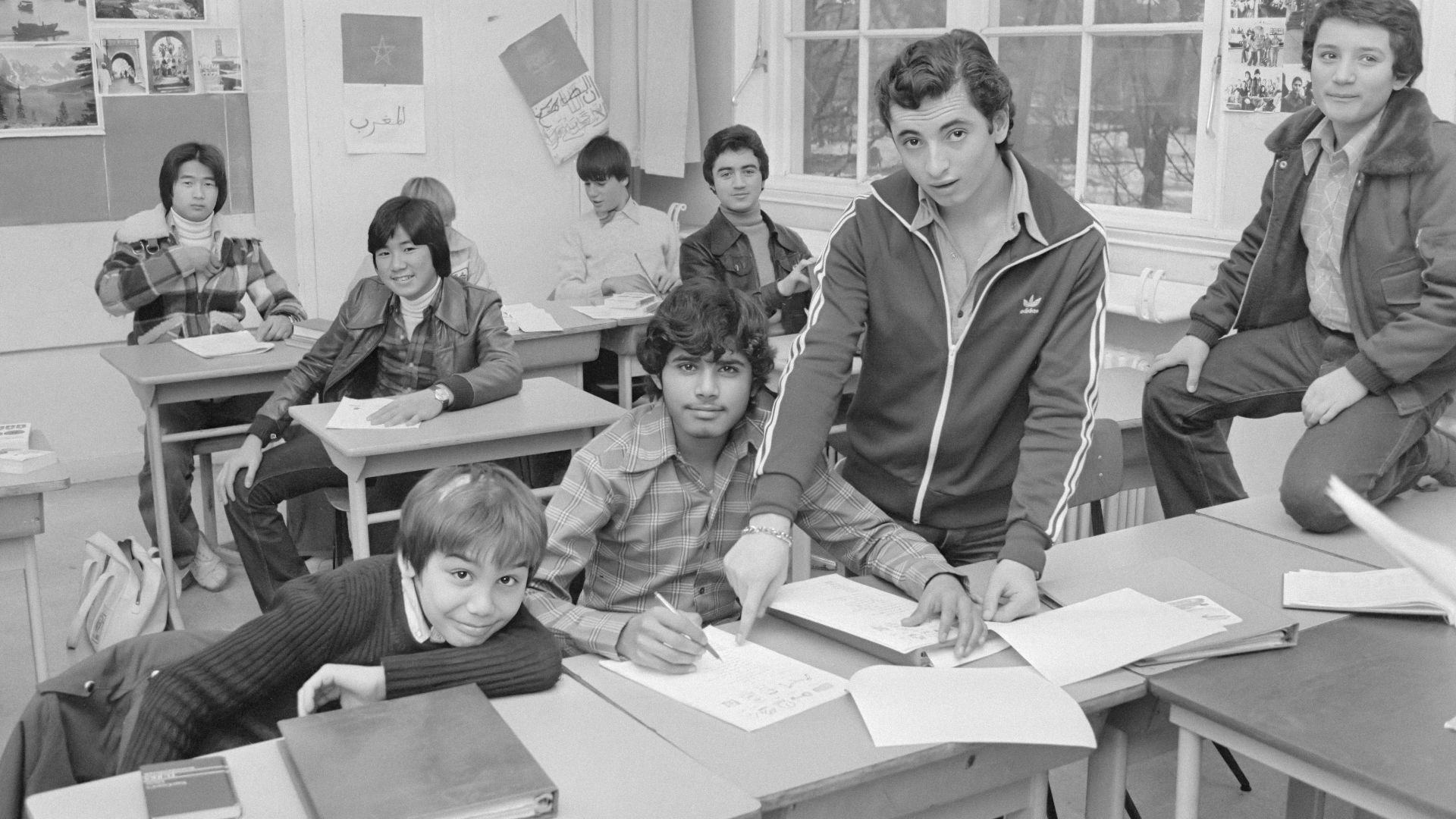 a group of kids sitting at desks in a classroom