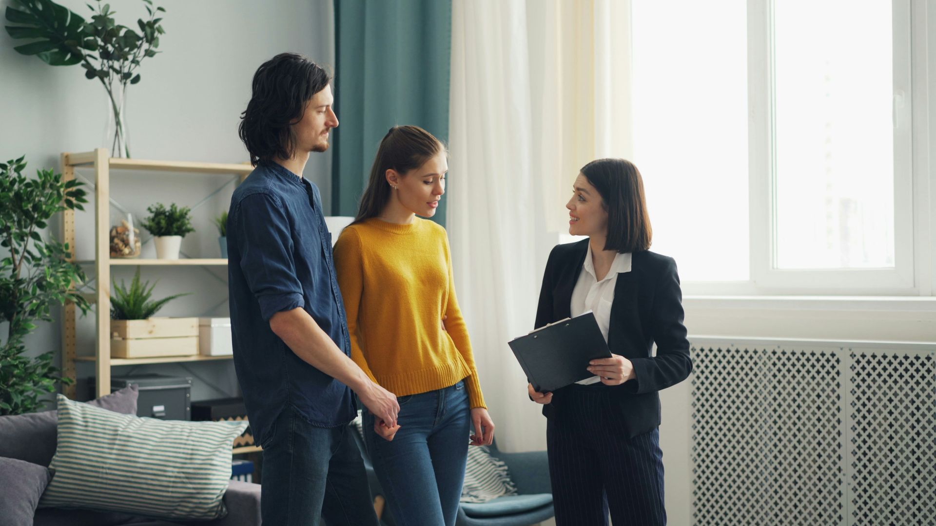a group of people standing in a living room