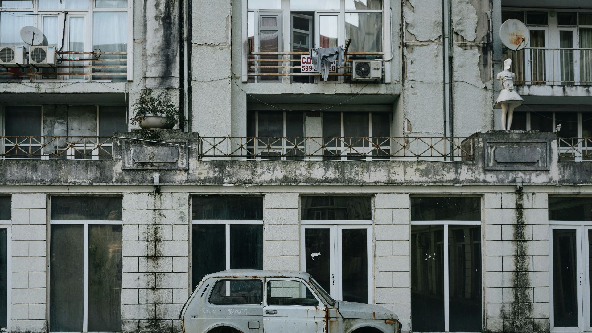 an old car parked in front of a building