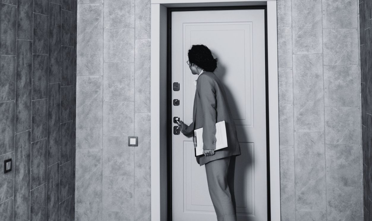Woman in brown suit viewing a new home interior