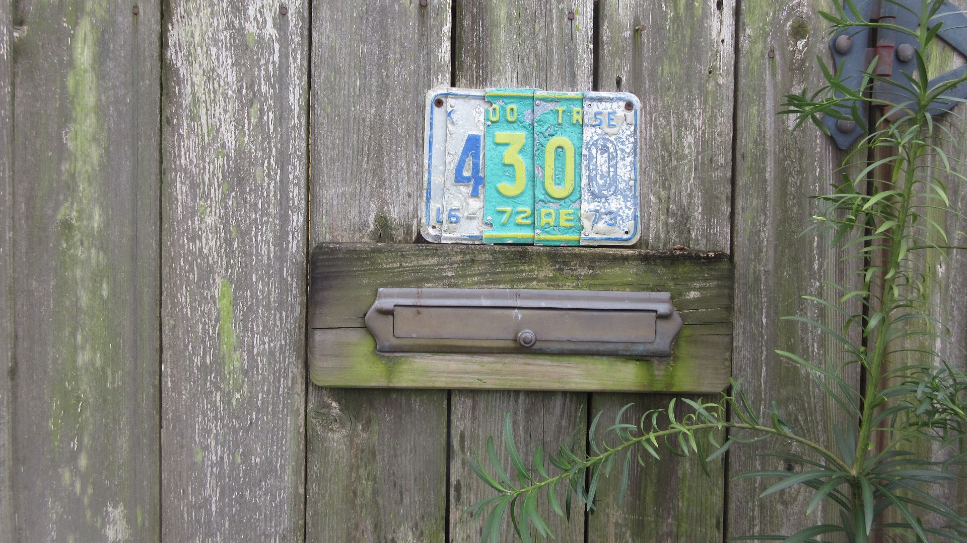 Gen Pershing Street, Uptown New Orleans.  Fence on side of house, the front of which faces Laurel Street, has a mail slot with the Laurel Street address number