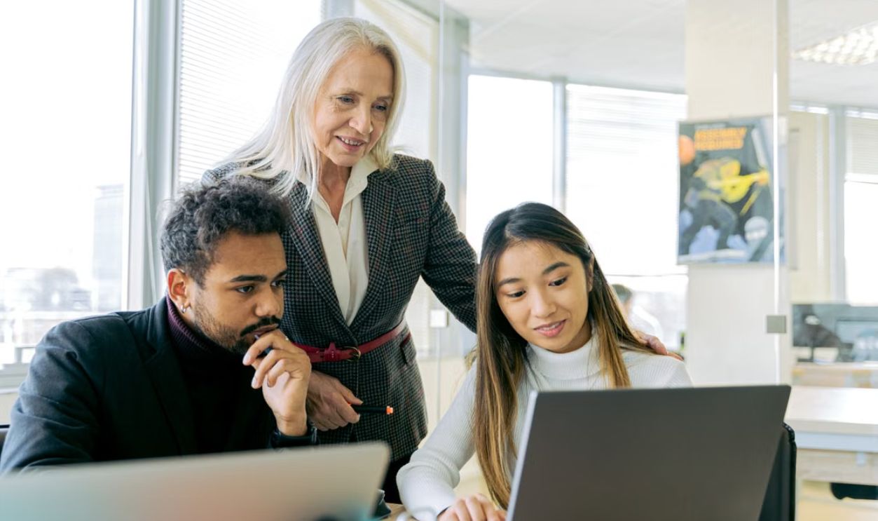 A diverse group of professionals engaged in a collaborative office meeting.