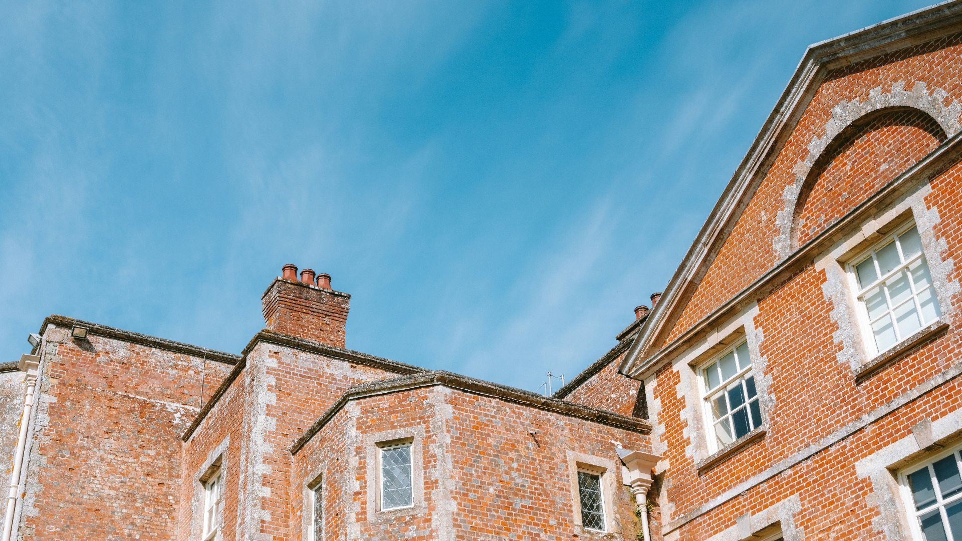 Brick building with white trim against blue sky
