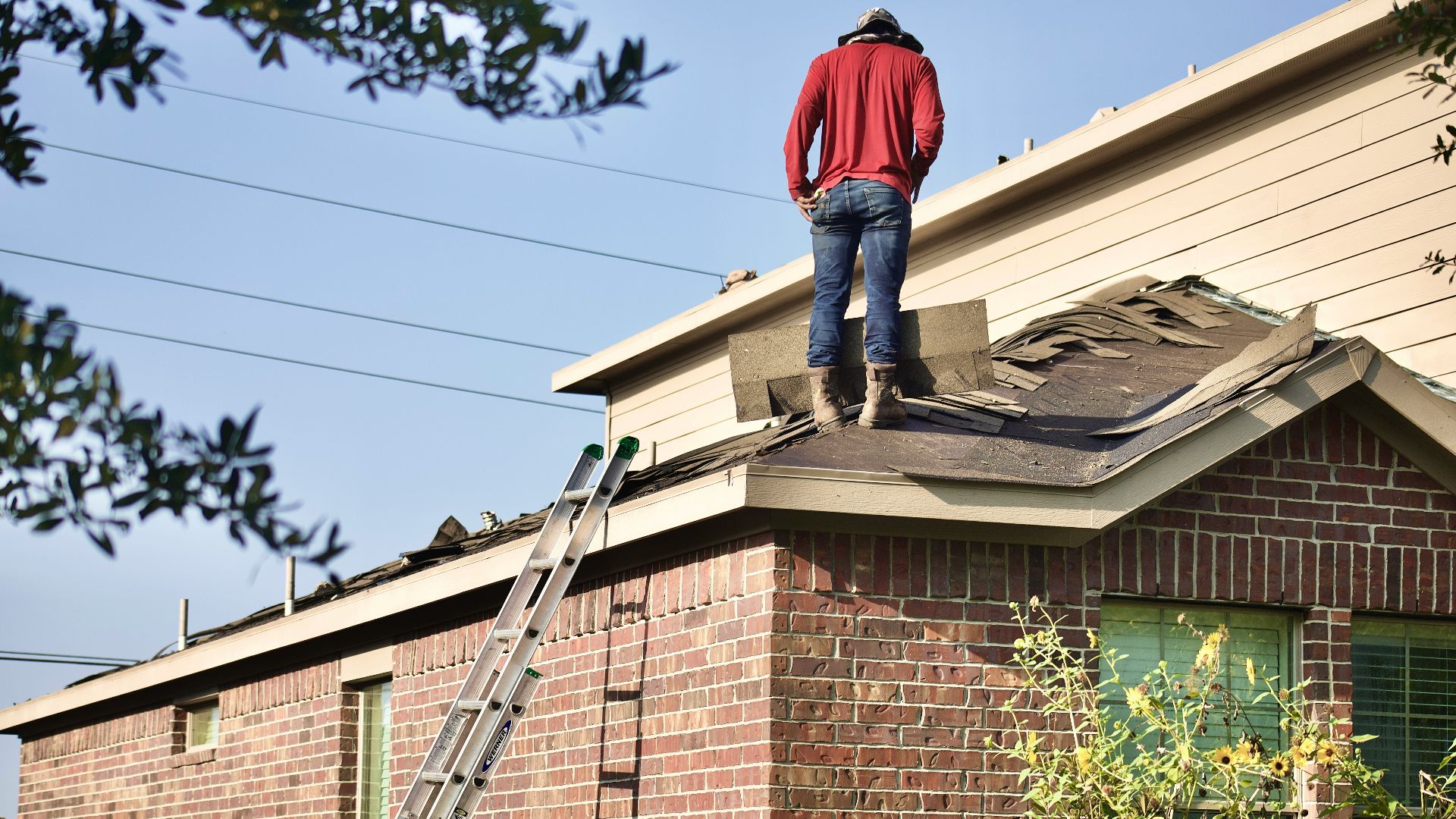 a man standing on the roof of a house