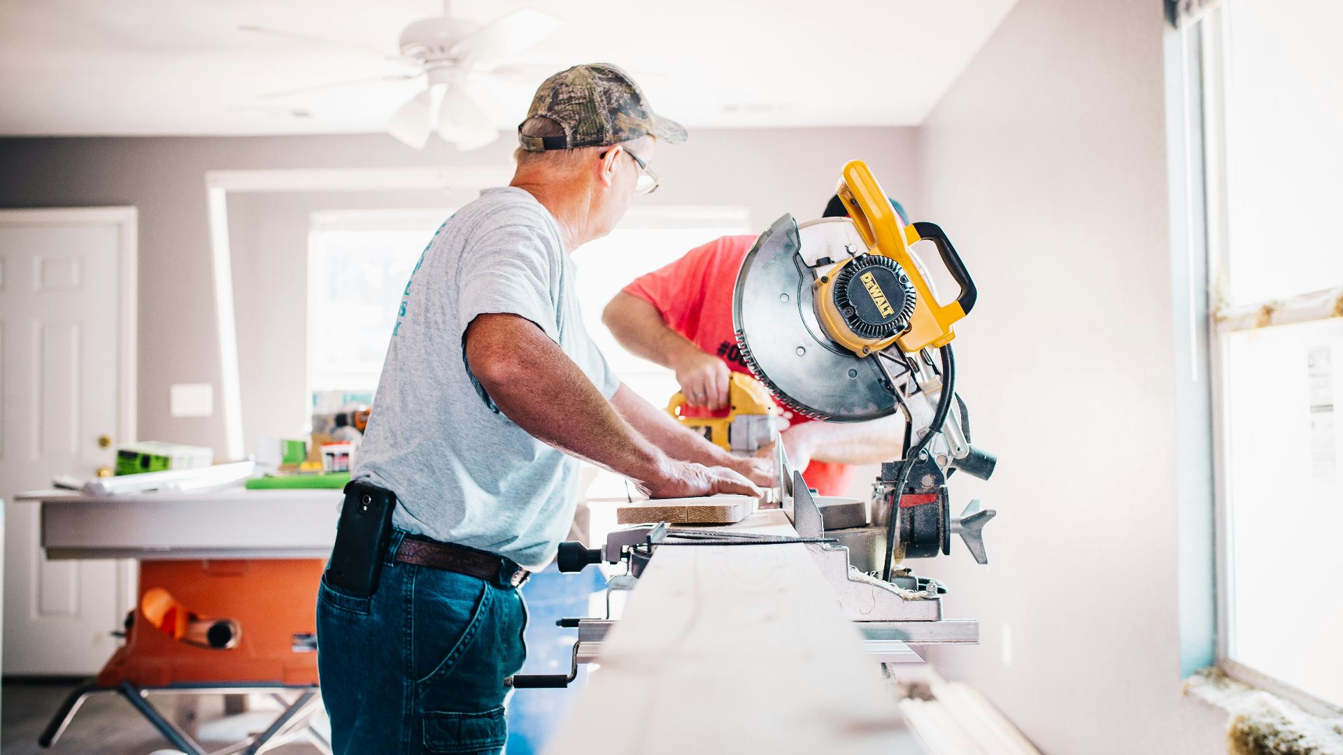 man standing infront of miter saw