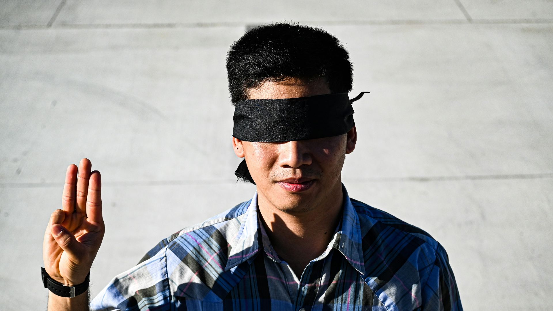 man in blue and white plaid button up shirt wearing black sunglasses