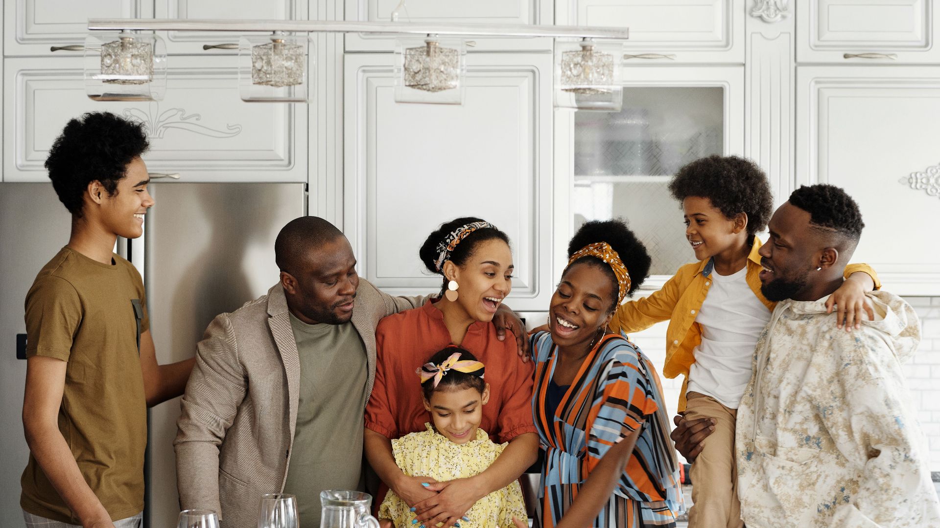 A happy family enjoying a gathering in a contemporary kitchen, sharing smiles and warmth.