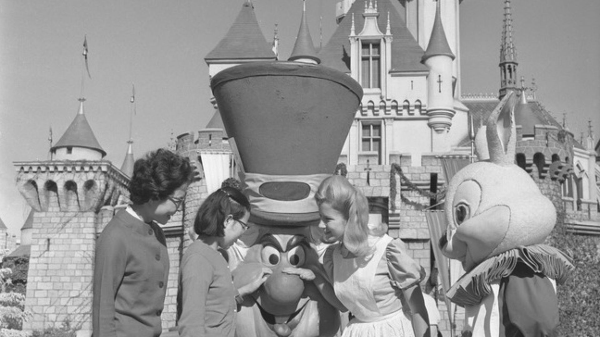 Korean student, Jong Sook Kim, visiting the Mad Hatter and Alice at Disneyland, 1964-01-05