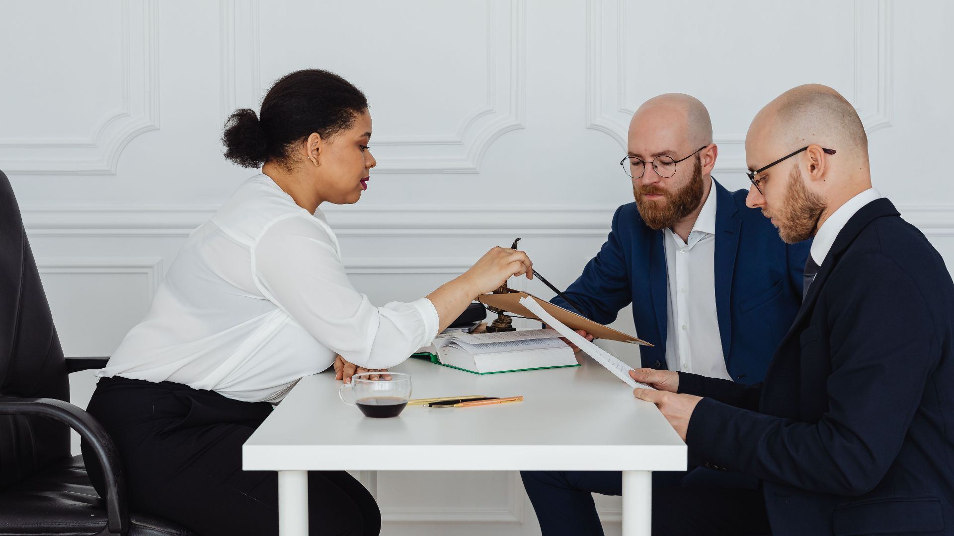 Business team discussing documents around table in office for project development.
