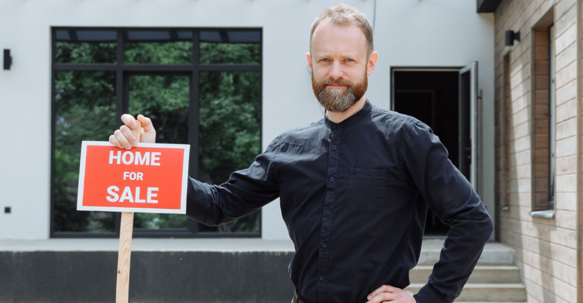 a-man-in-black-long-sleeves-holding-a-signage