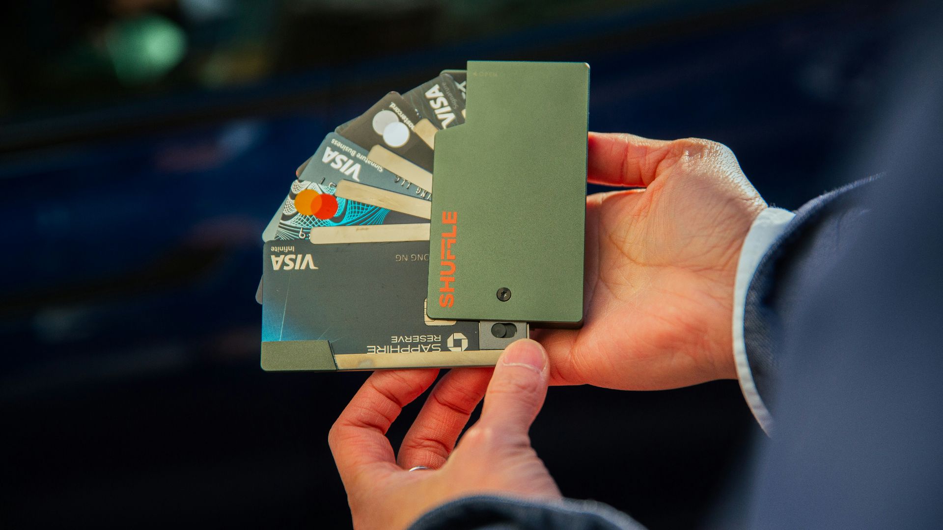 a person holding several credit cards in their hand