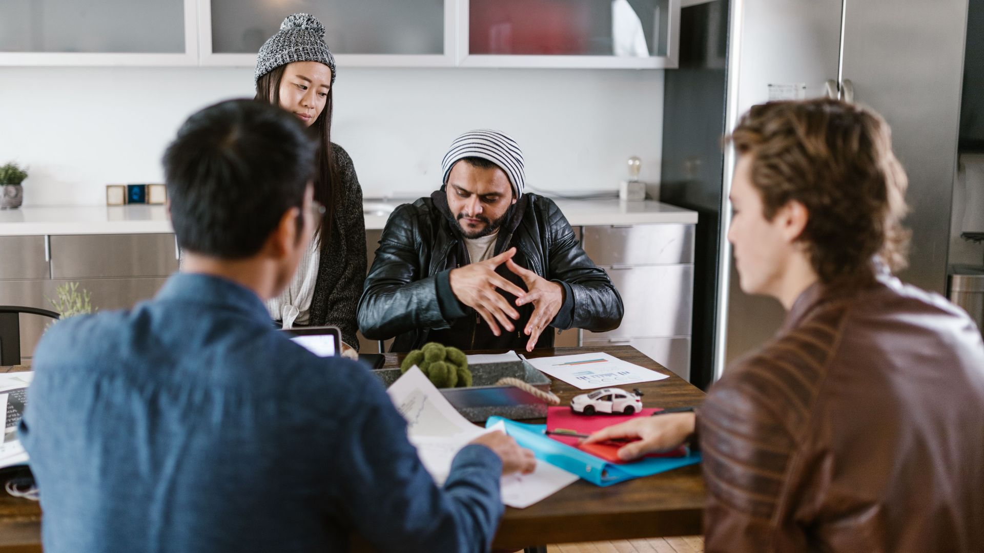 A group of diverse colleagues in a modern office setting engaged in a brainstorming session.