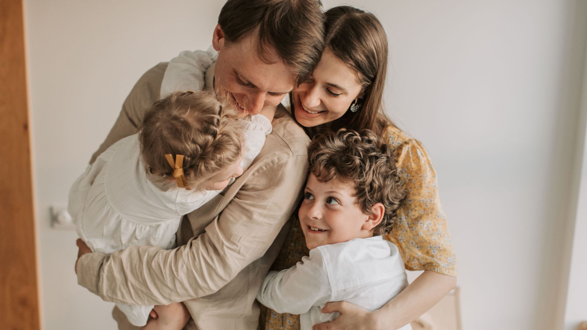 A heartwarming scene of a family hugging indoors, showcasing love and togetherness.