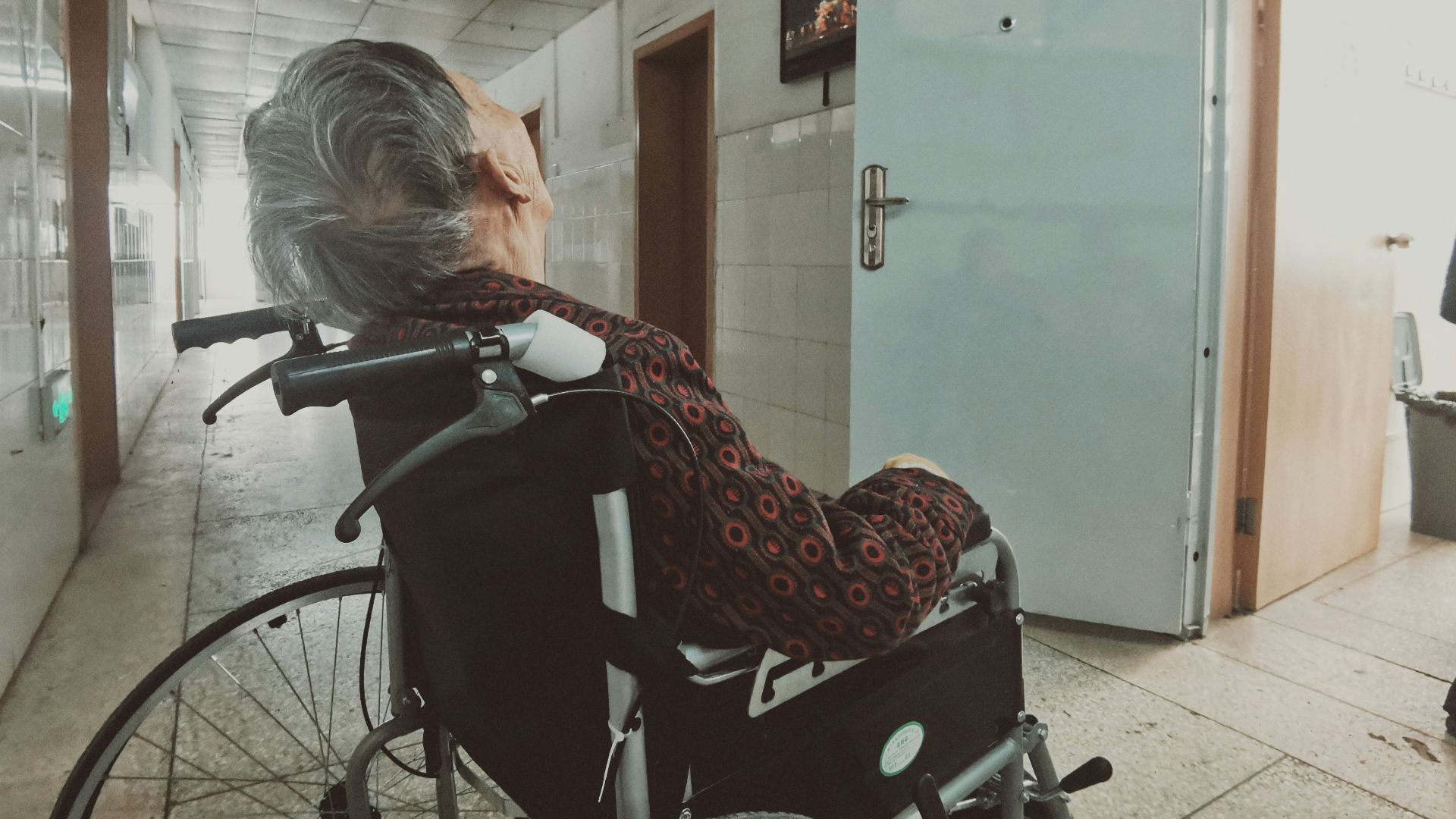 woman in black and white long sleeve shirt sitting on black wheelchair