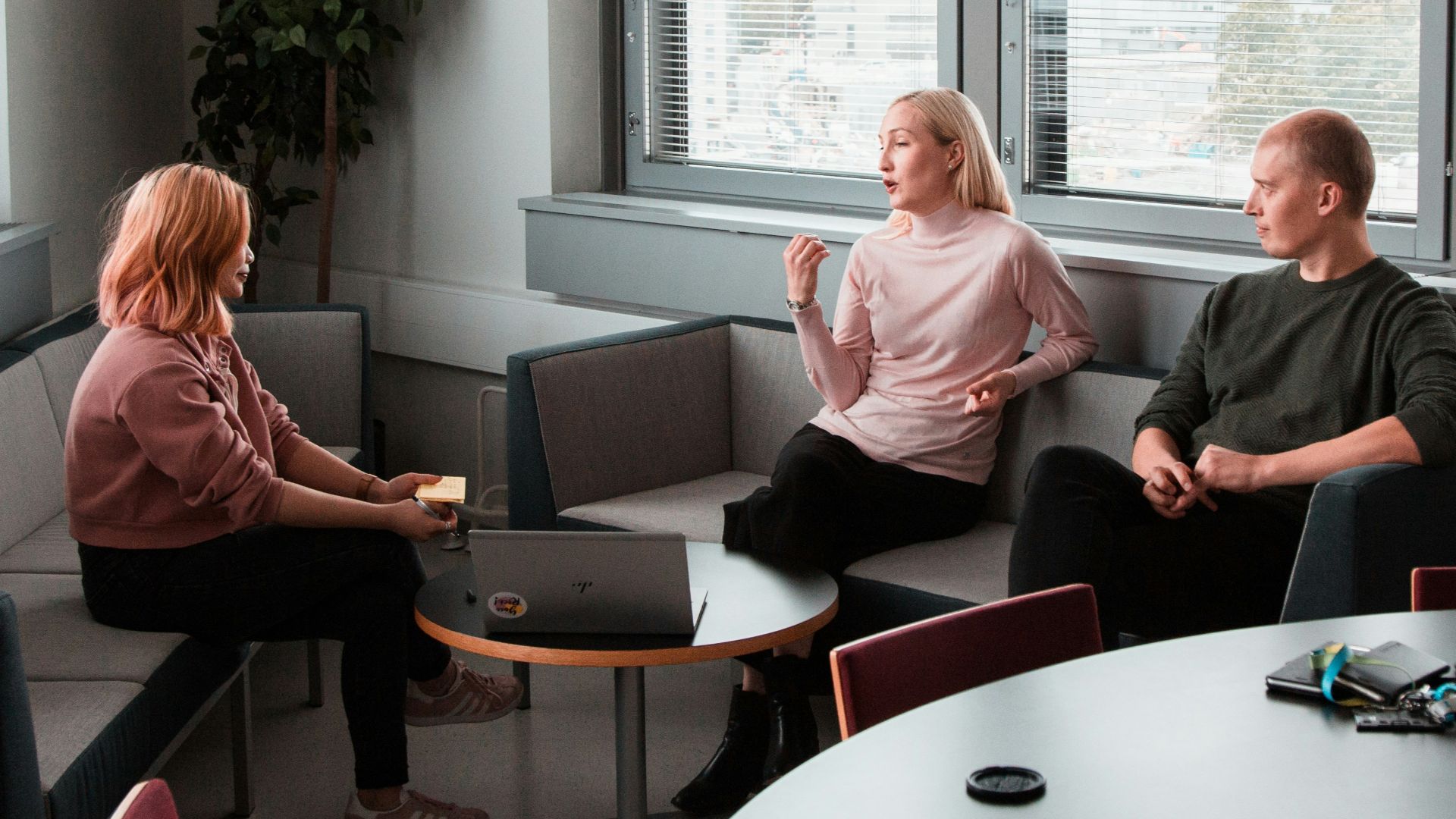 2 women sitting on black sofa