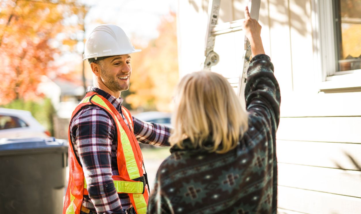 A man with hard hat talking with customer