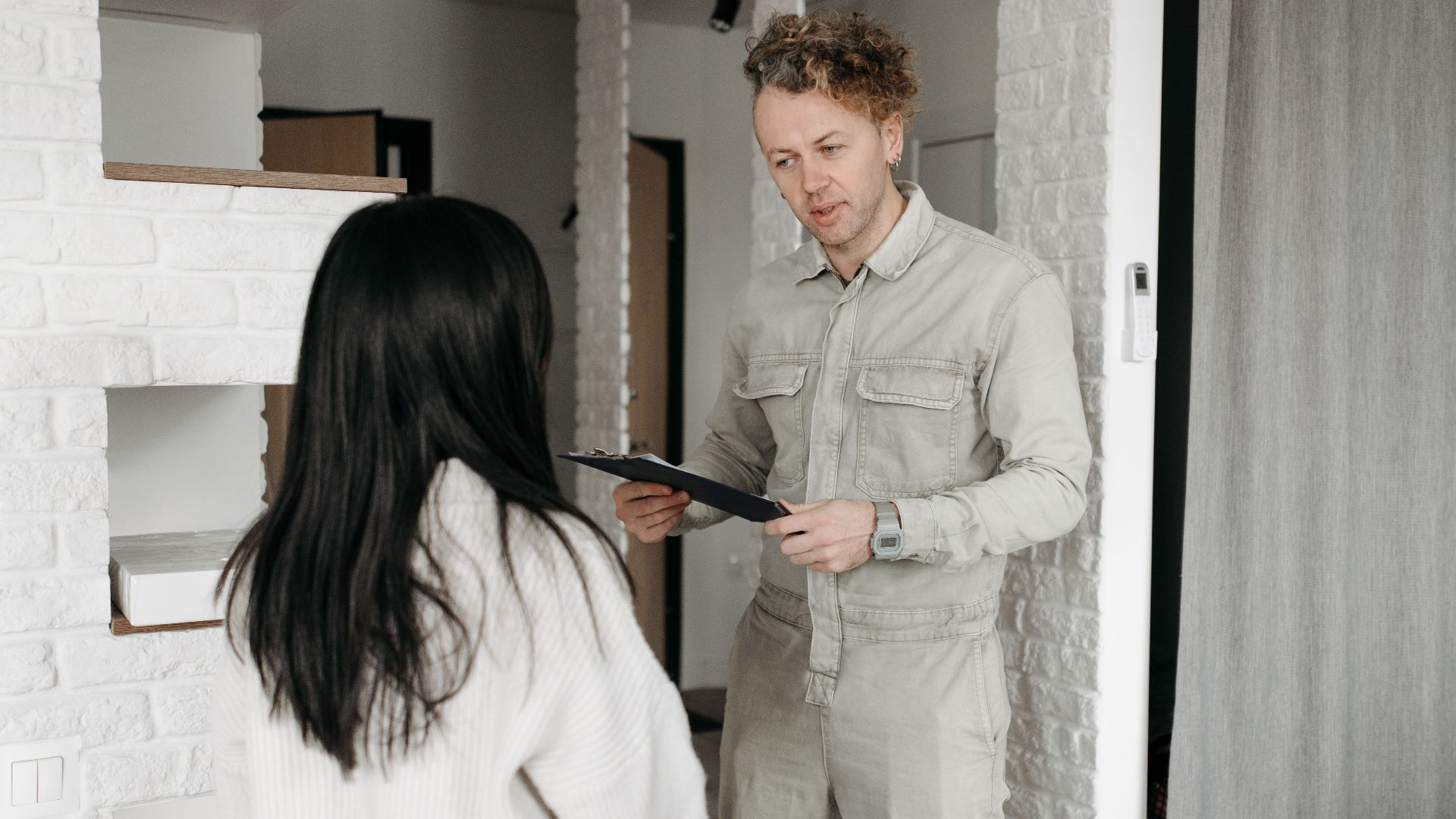 Courier hands over a package to a customer in a modern indoor setting, promoting online shopping services.