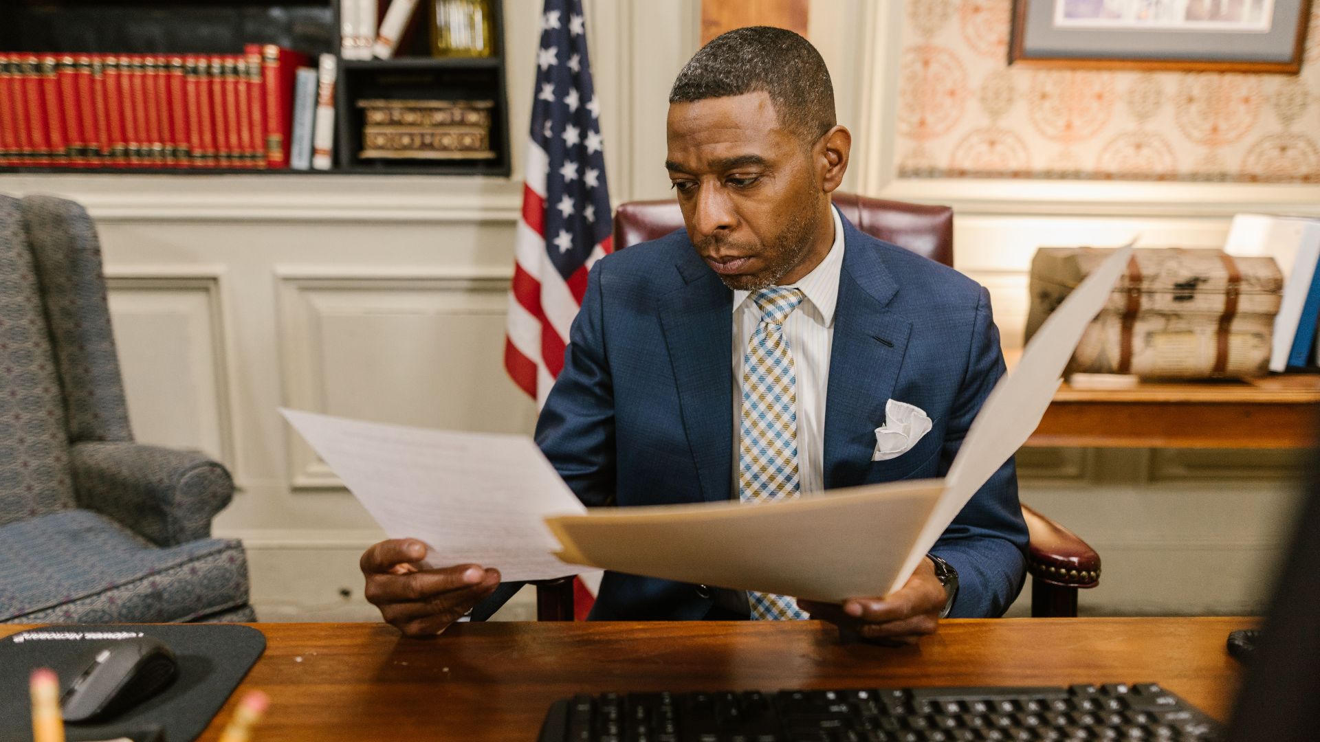 A lawyer reading documents in an office setting, conveying professionalism and focus.