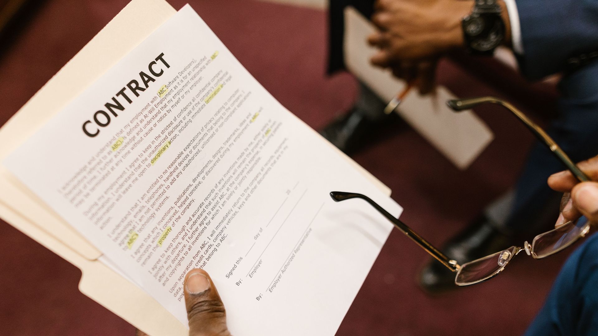 Close-up of hands holding a contract, focus on business agreement discussion.