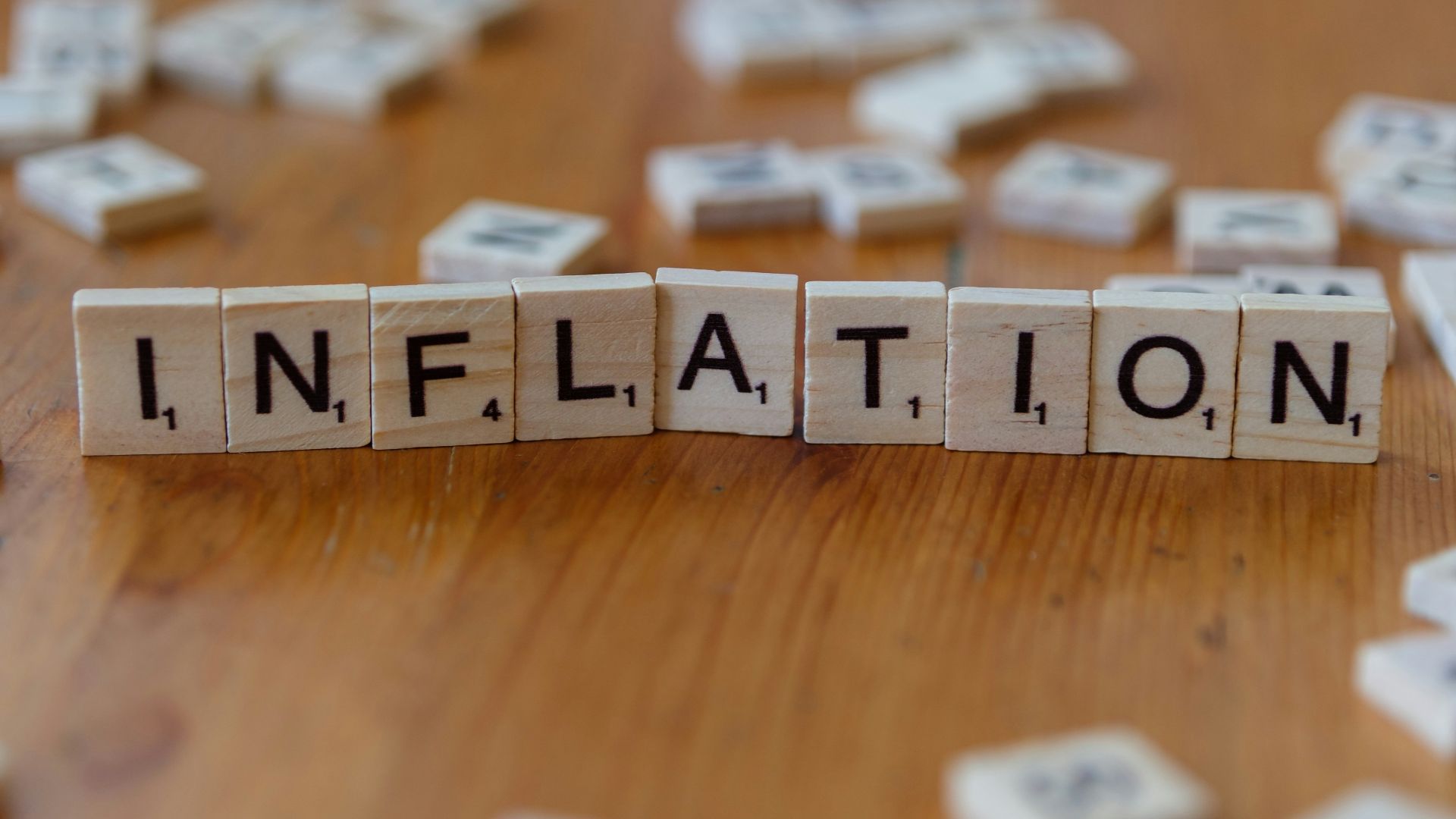 Inflation is spelled out using scrabble tiles.