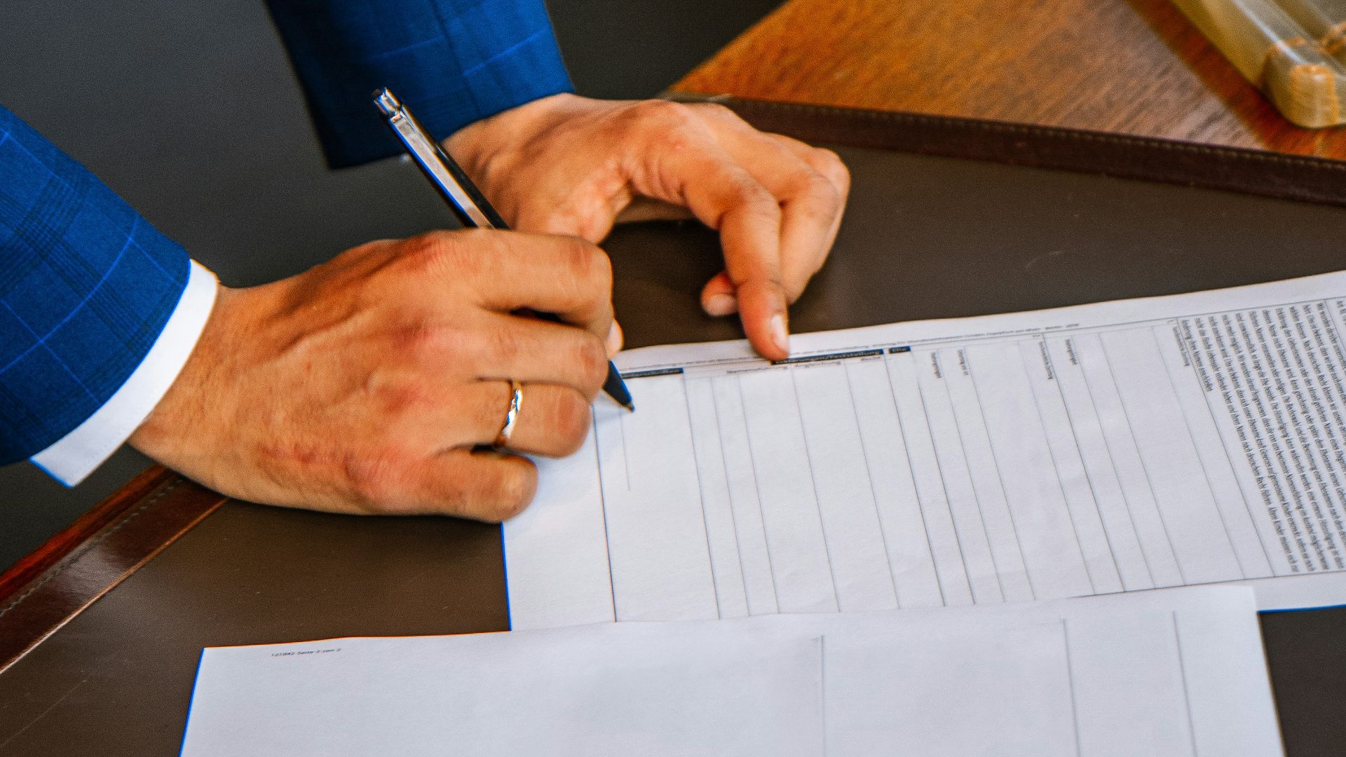 person writing on white form paper
