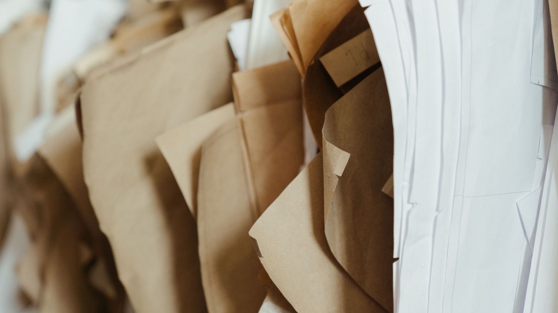 Detailed close-up of assorted sewing patterns on brown and white craft paper, perfect for DIY projects.