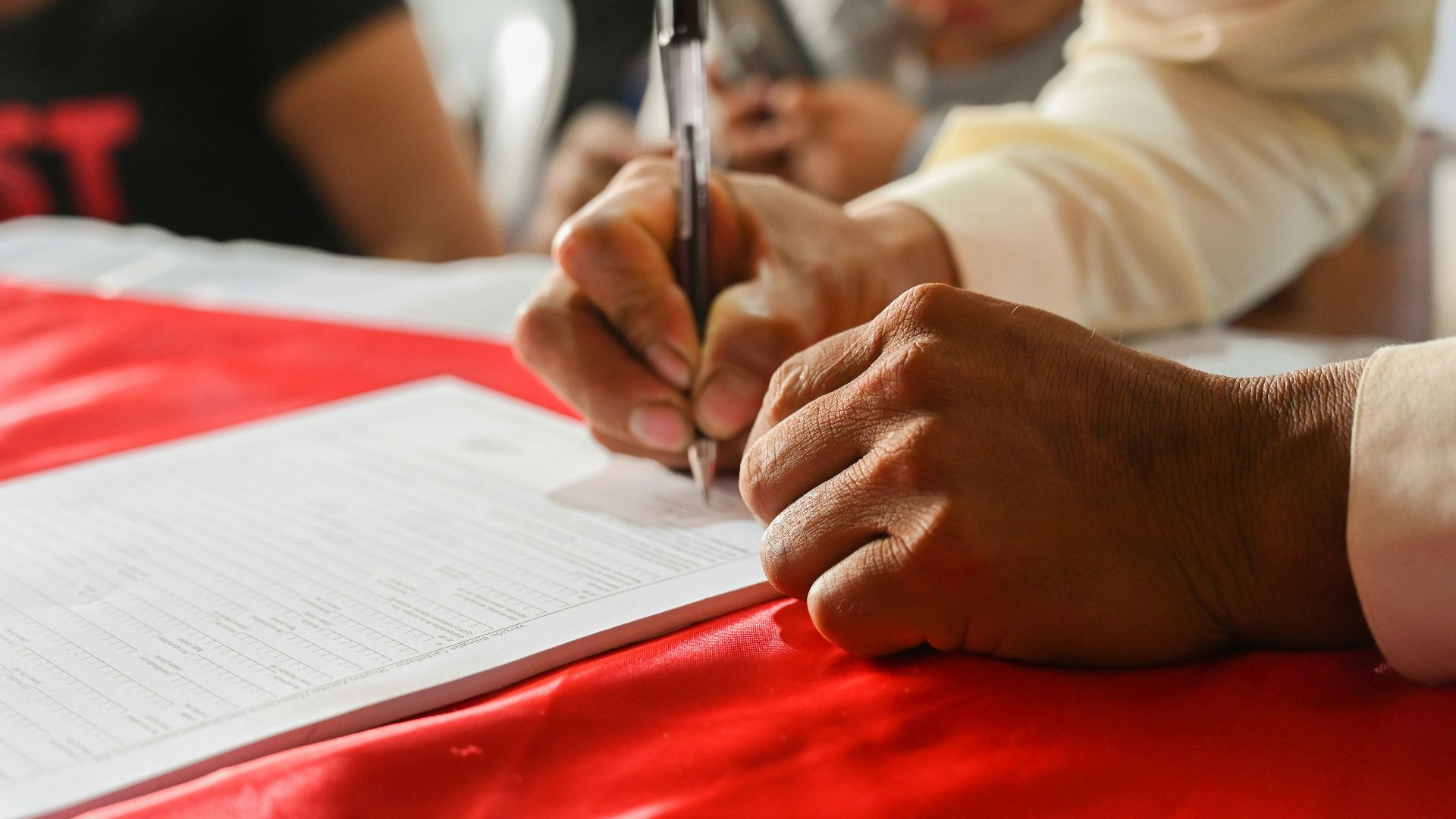 a person writing on a piece of paper