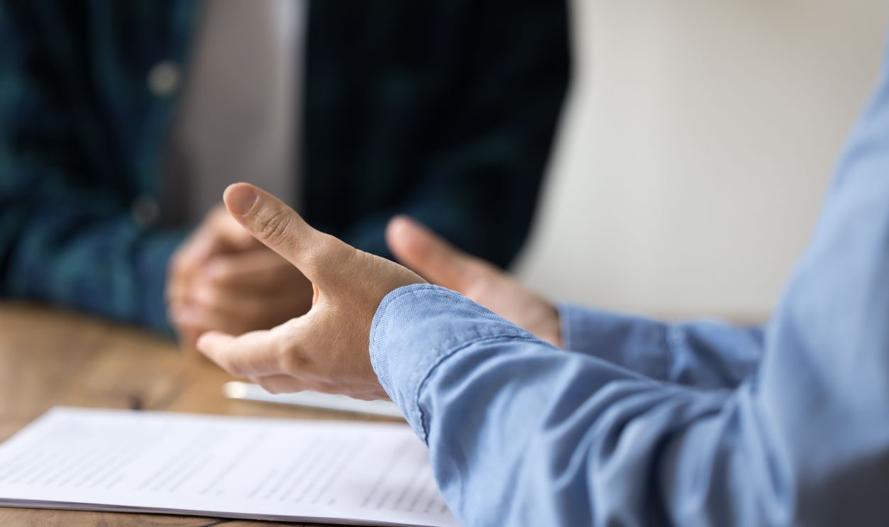 Customer consultation. Close up female business consultant legal advisor explain paper contract terms conditions to client during mentoring conversation. Presenting agreement paperwork support concept