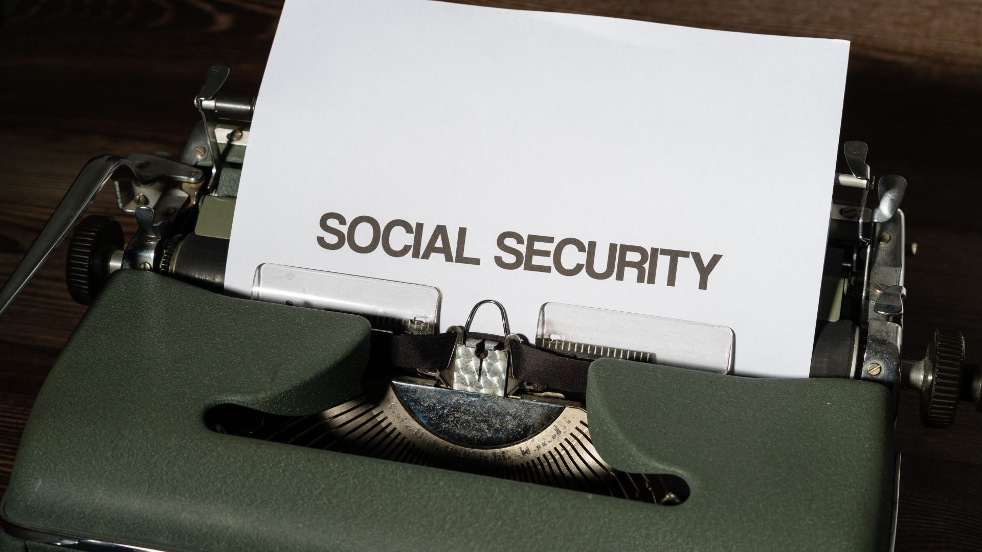 Close-up of a vintage typewriter typing 'SOCIAL SECURITY' on paper, classic concept.