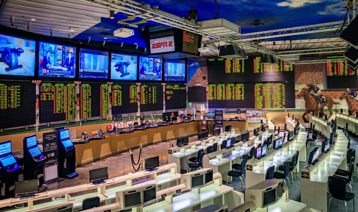 Las Vegas, Nevada, USA - October 25, 2021: An empty sportsbook with numerous screens displaying odds and live sports, and rows of betting stations