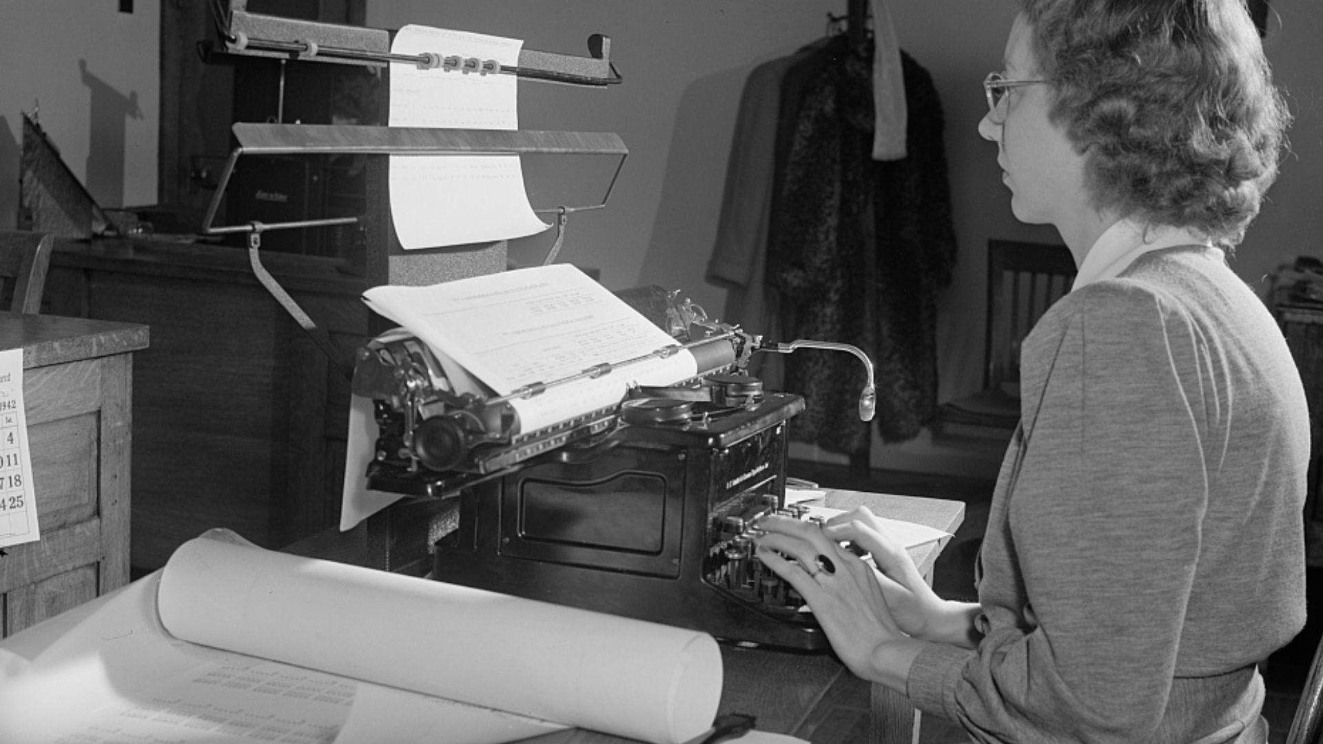 Female typist working on statistical tables.