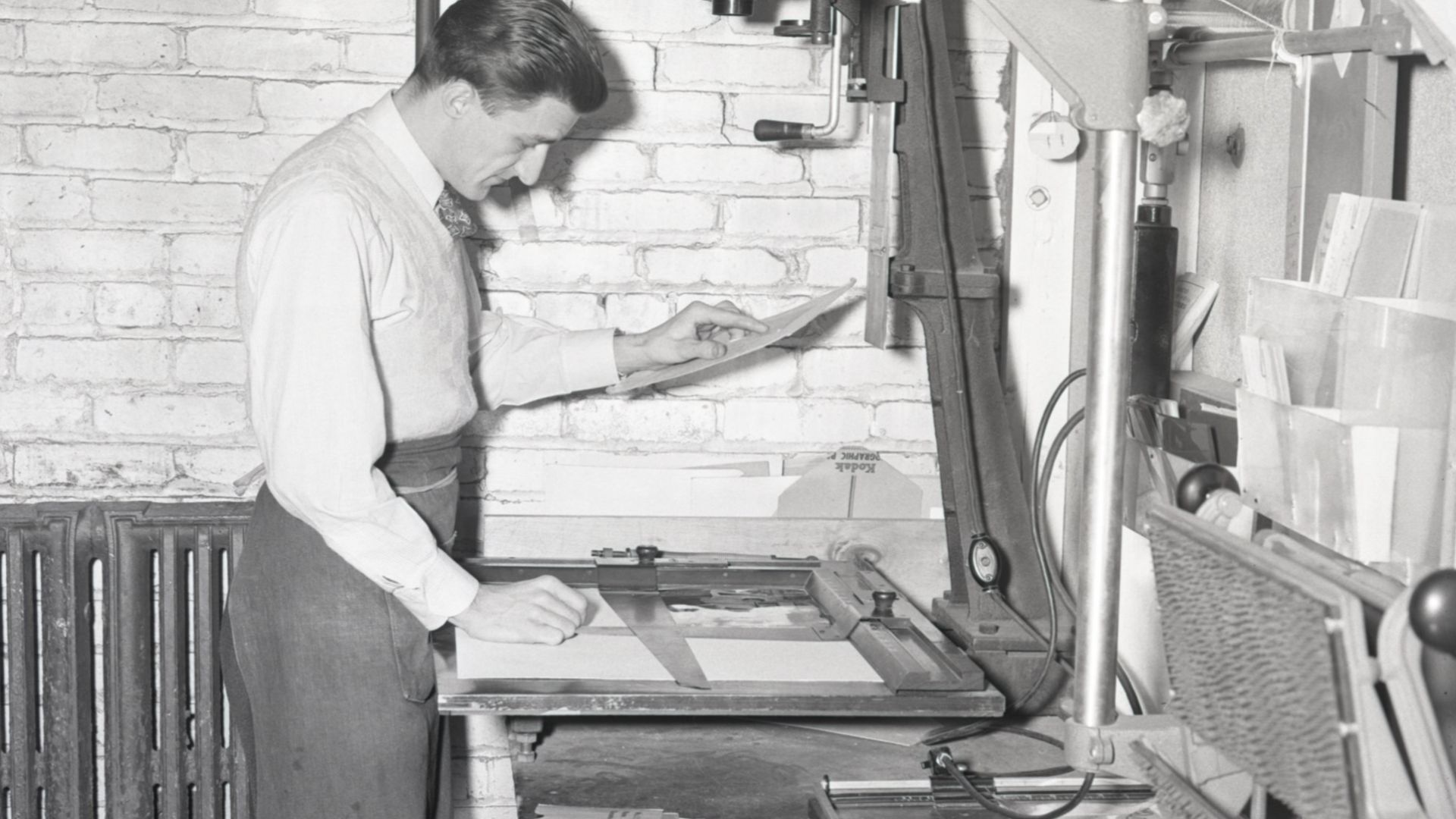 General view of senior photo technician Ford Bowers printing photographs in the Dow Chemical Company's Photographic Laboratory. Established in the 1930's, the Photo Lab took pictures for employee publications like The Brine Well and Dow Diamond, as well a