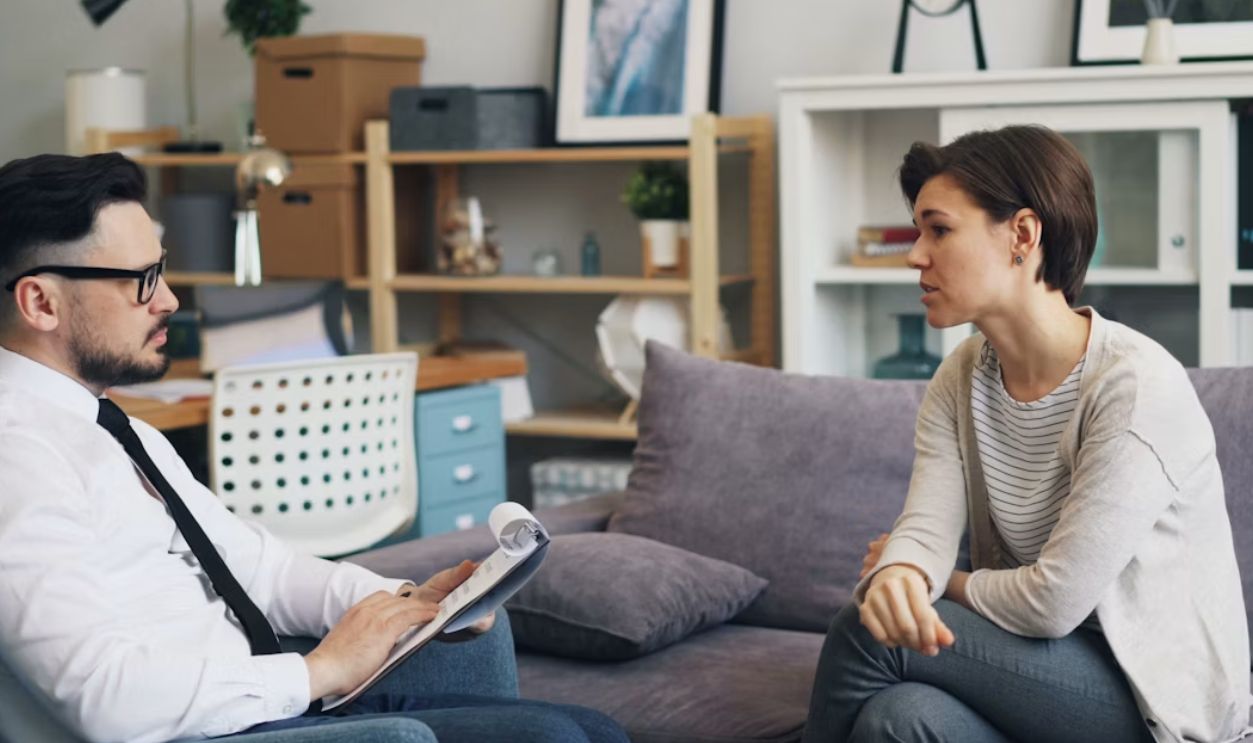 a man and a woman sitting on a couch talking