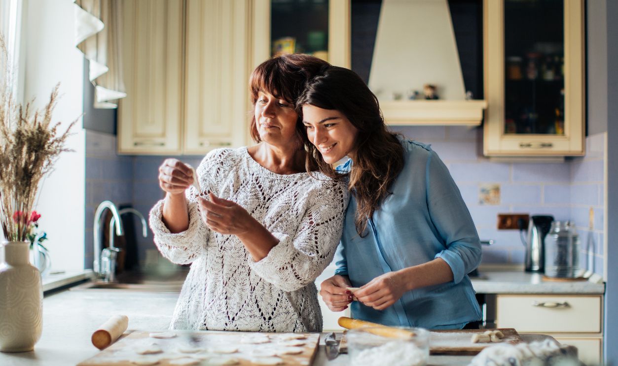 Mother and daughter bonding while making dumplings in a cozy kitchen setting