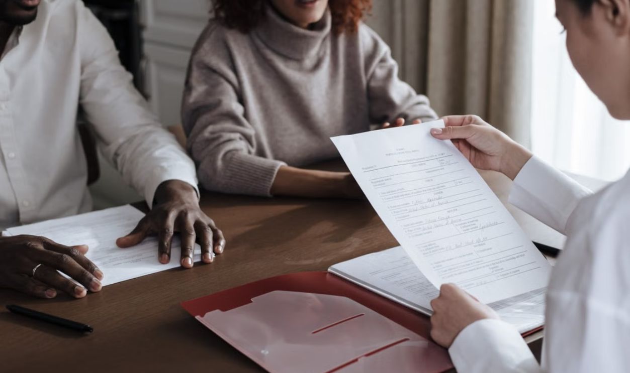 couple talking with a professional advisor for advice 