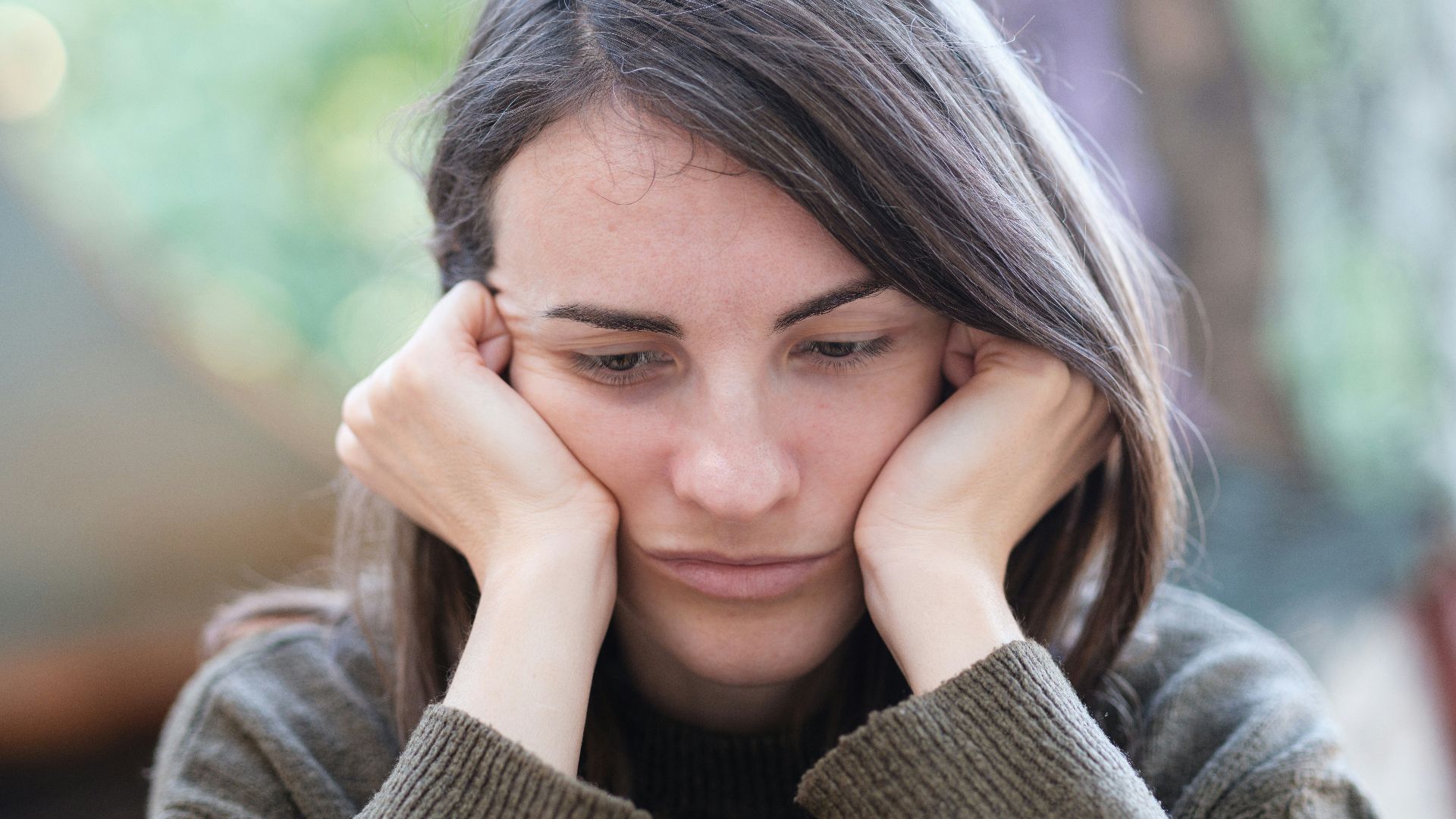 a woman holding her head in her hands