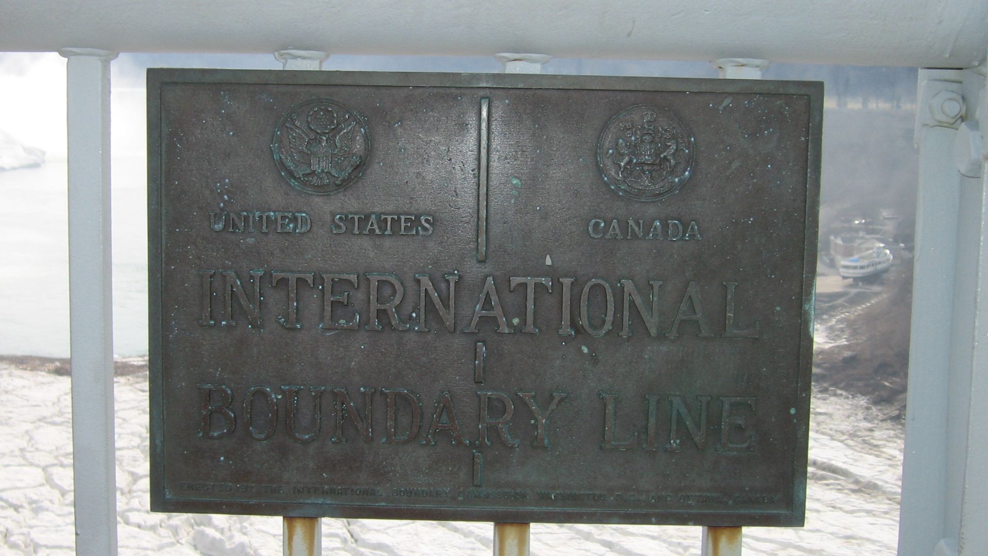 USA-Canada border sign at the Rainbow Bridge, Niagara Falls.
Inscription:
United States | Canada International Boundary Line / Erected by the International Boundary Commission Washington D.C., and Ottawa, Canada