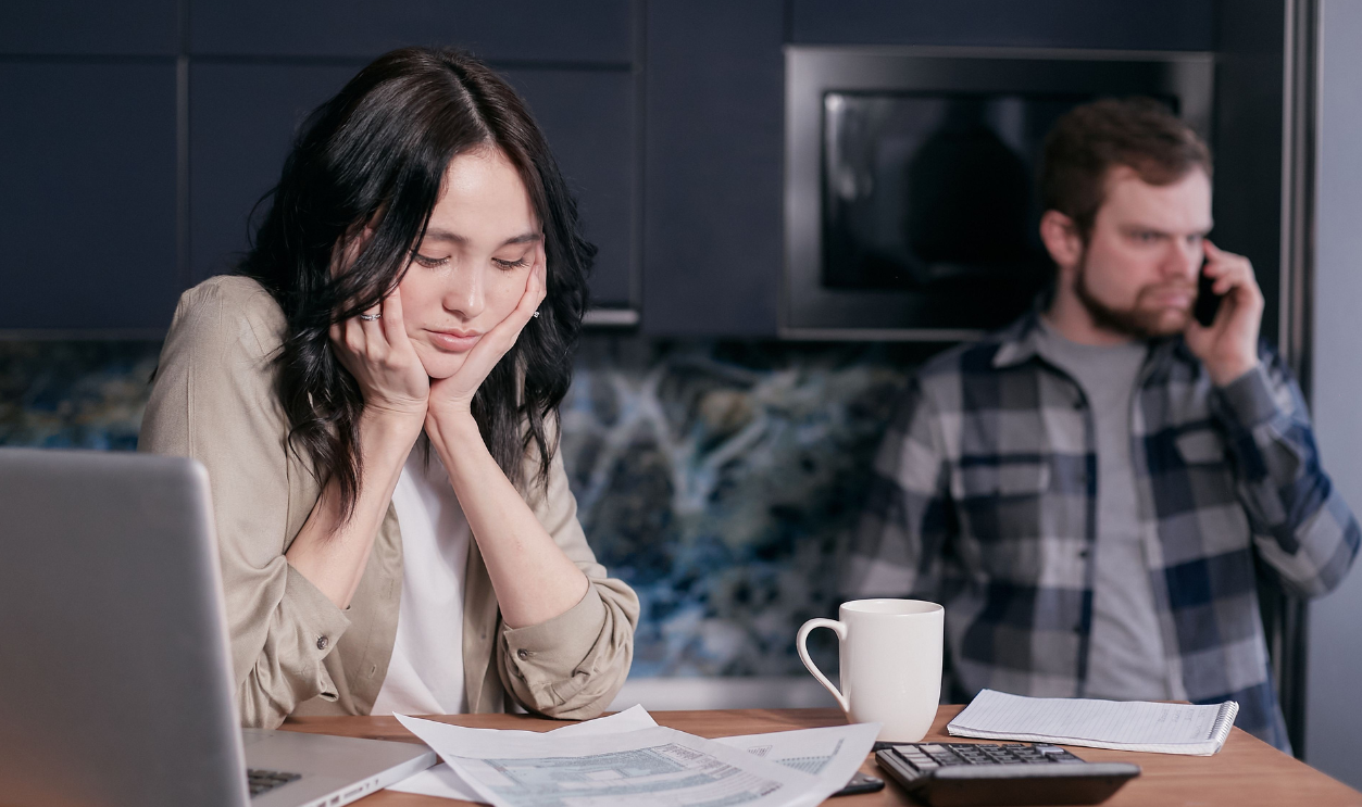 a-woman-looking-at-a-document-resting-her-chin-on-her-hands