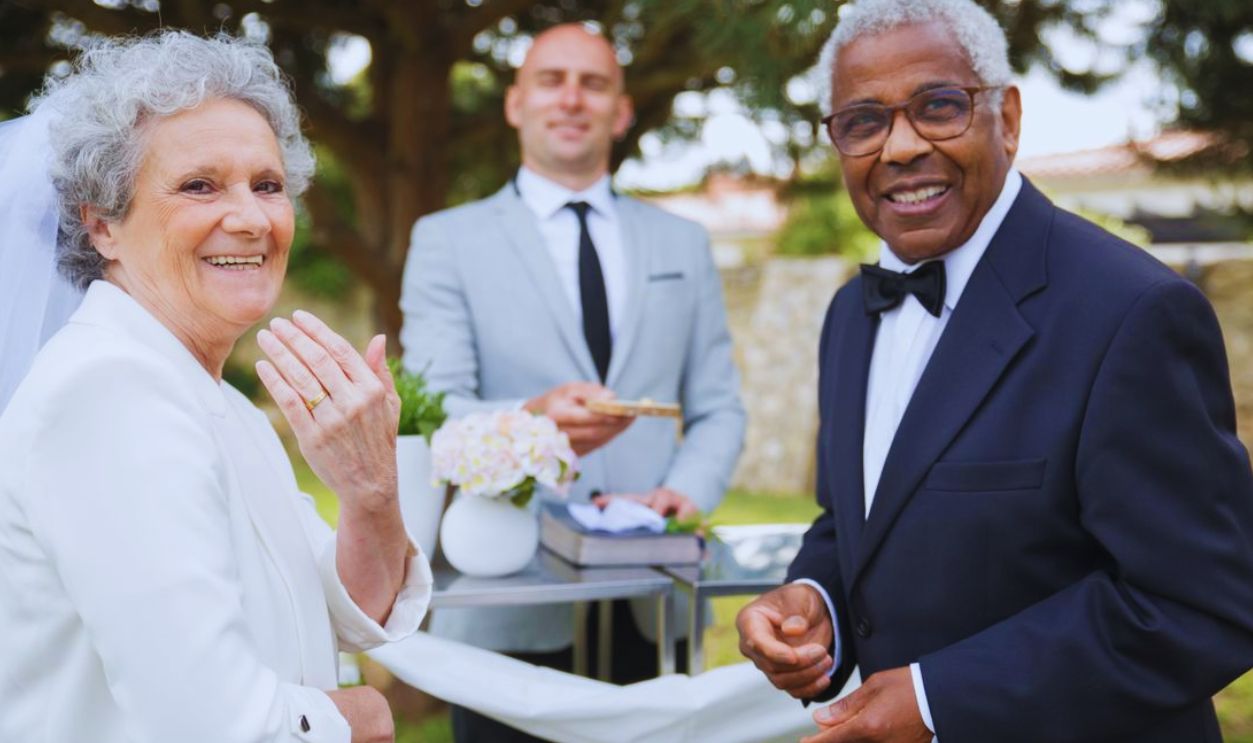 Happy senior couple celebrating their outdoor wedding ceremony.