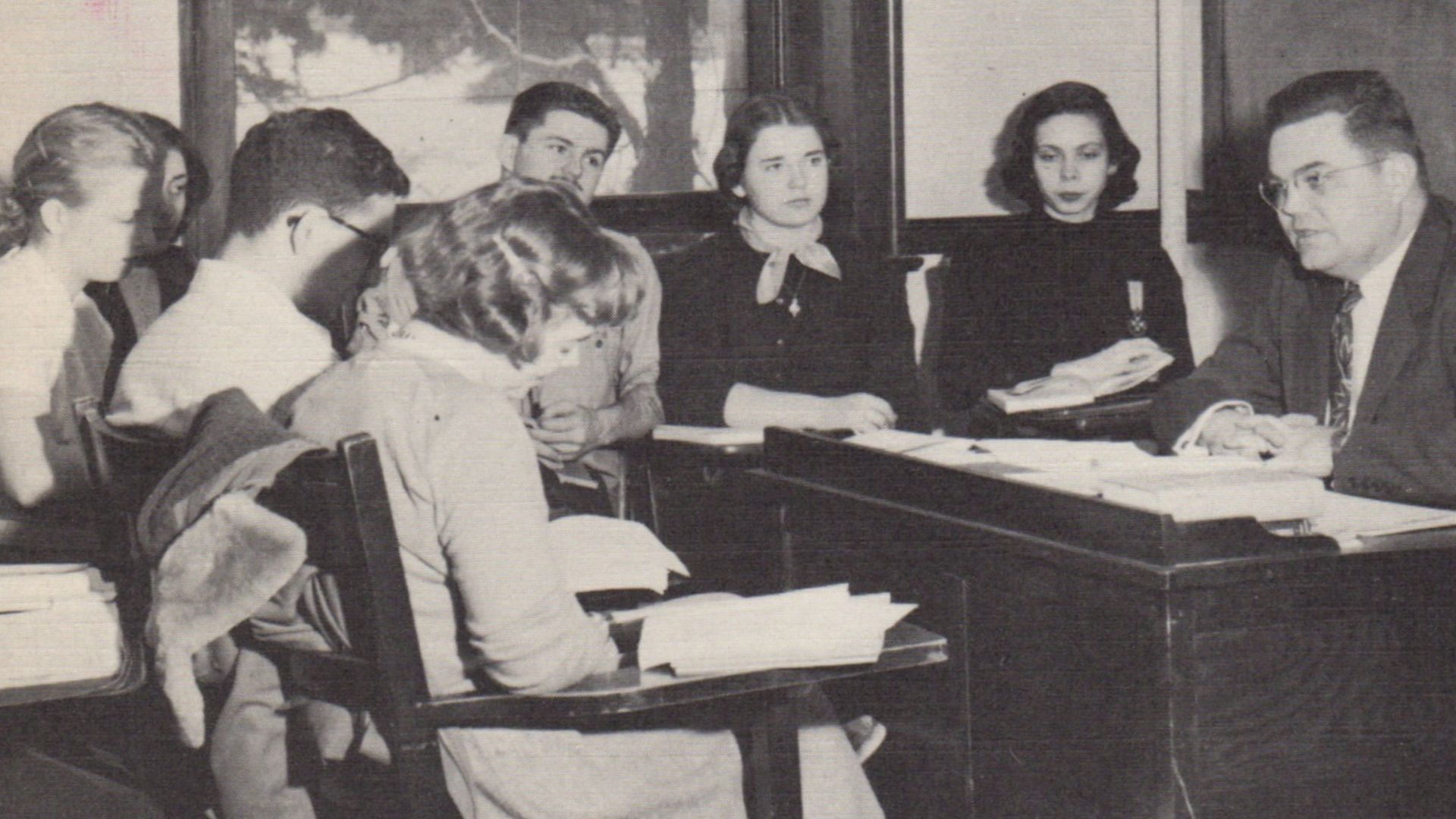 Photograph of an English class facilitated by Philip Tripp at Shimer College in 1951-1952, from the 1952 Shimer yearbook. Now a liberal arts college in Chicago, Shimer was then located in Mount Carroll, Illinois.  Shimer had switched from a girl's junior 