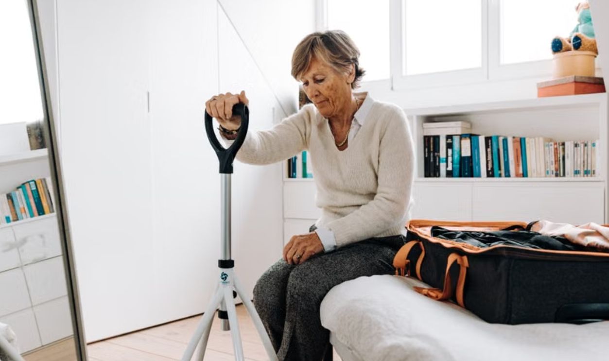 elderly woman sitting on the bed