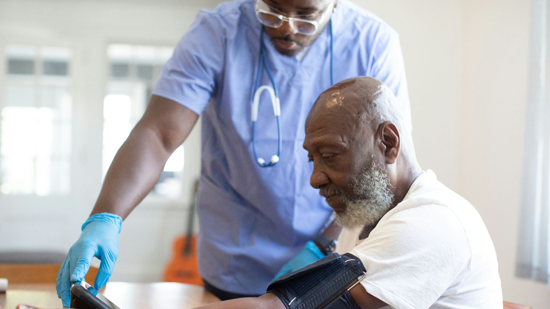 a doctor checking a patient's blood pressure